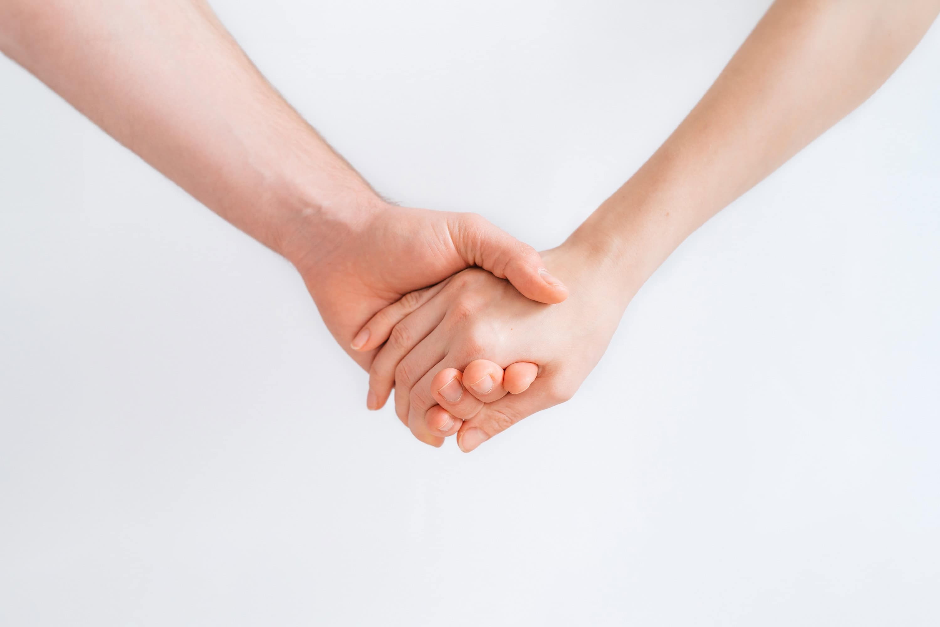 Two hands holding — a quiet image of support during grief