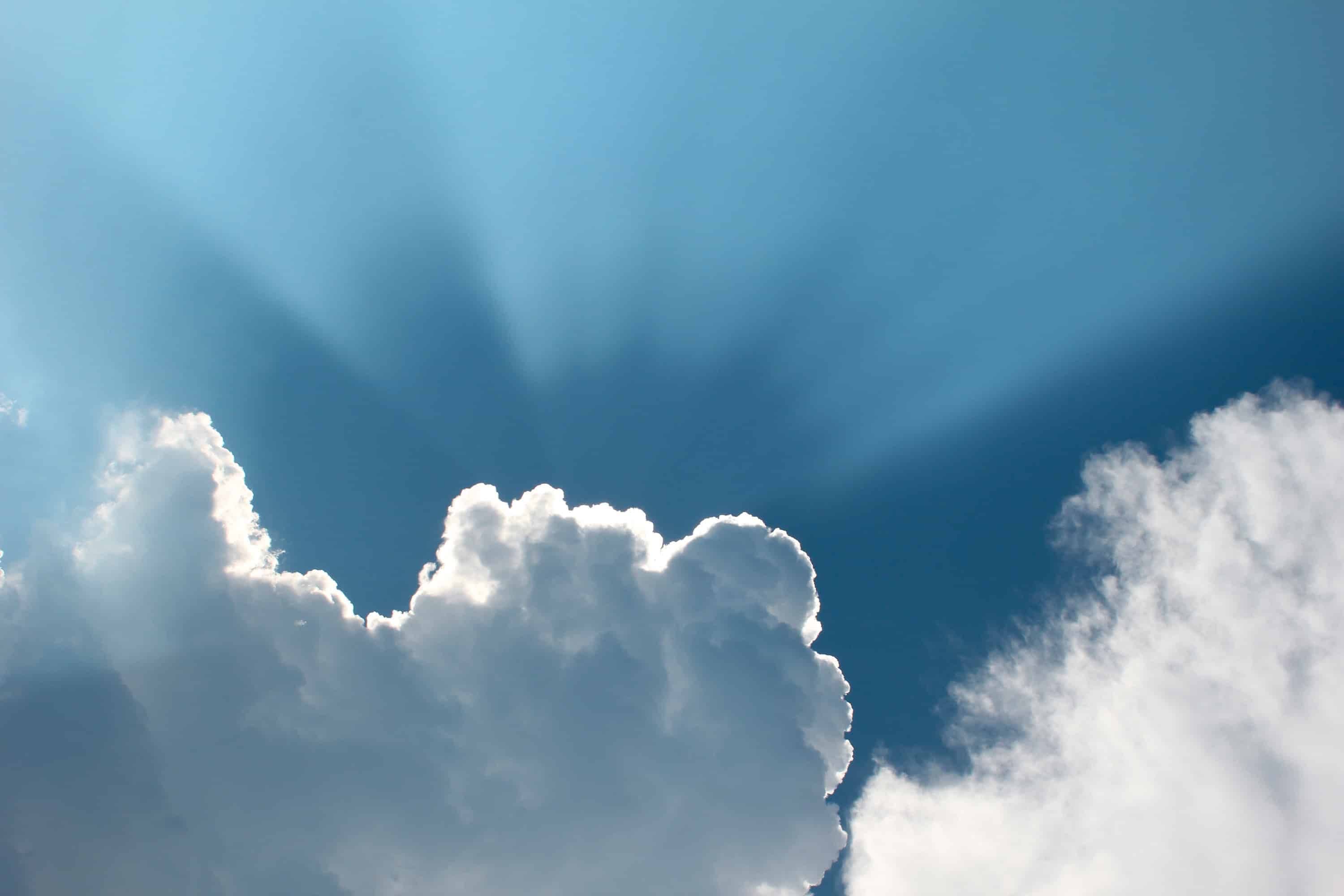 Sunlight breaking through clouds — a calm image for a virtual memorial service