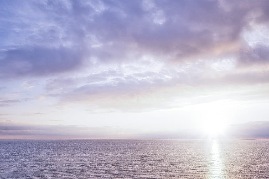Calm ocean and soft sky at sunrise